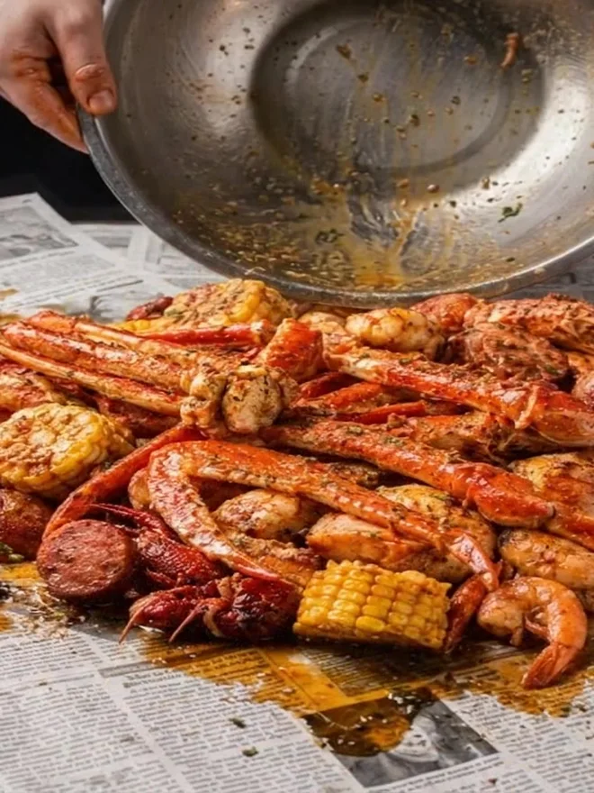The finished spread on newspaper with crawfish and corn